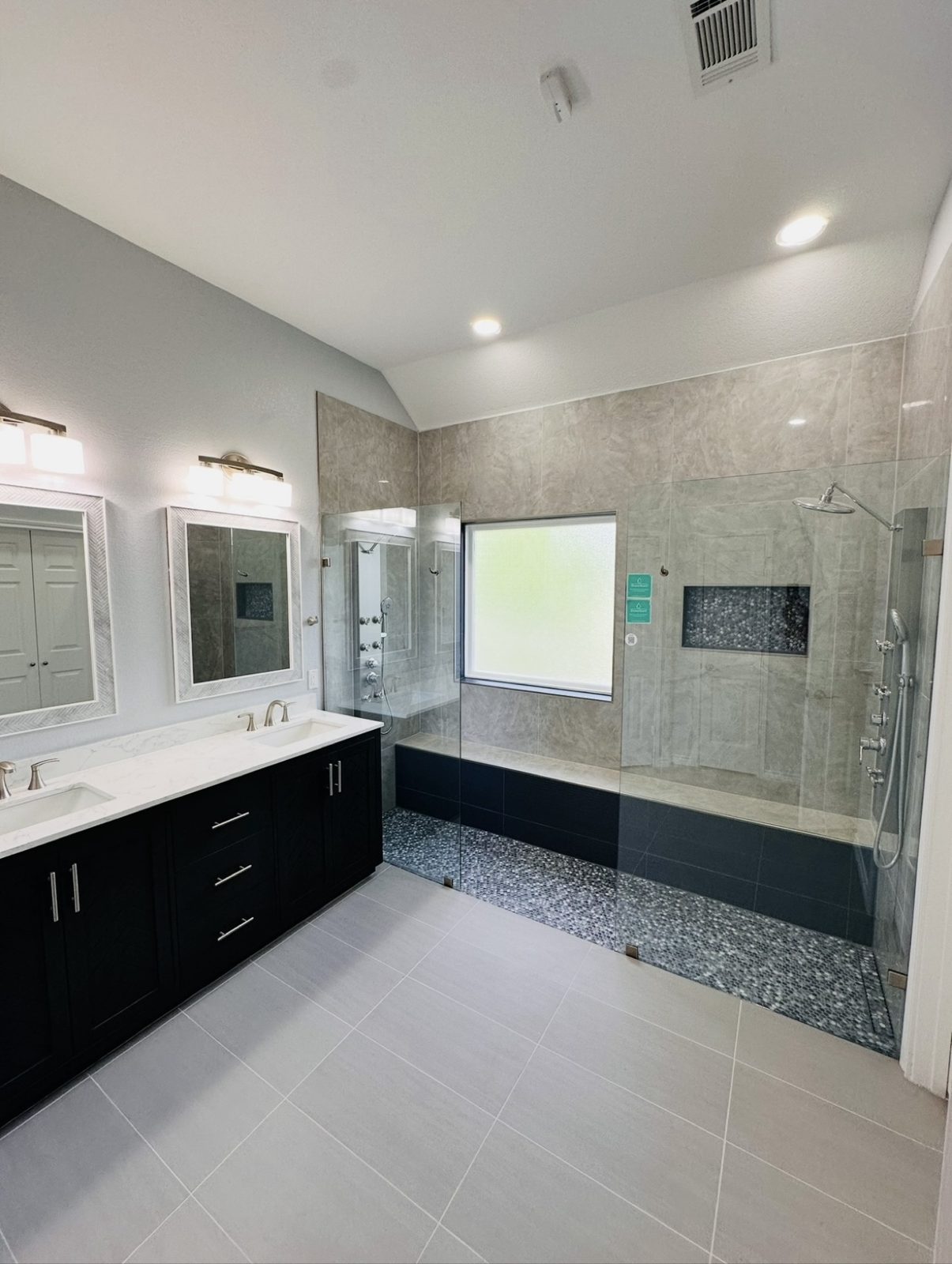 Full master bathroom remodel with double vanity and glass-enclosed shower