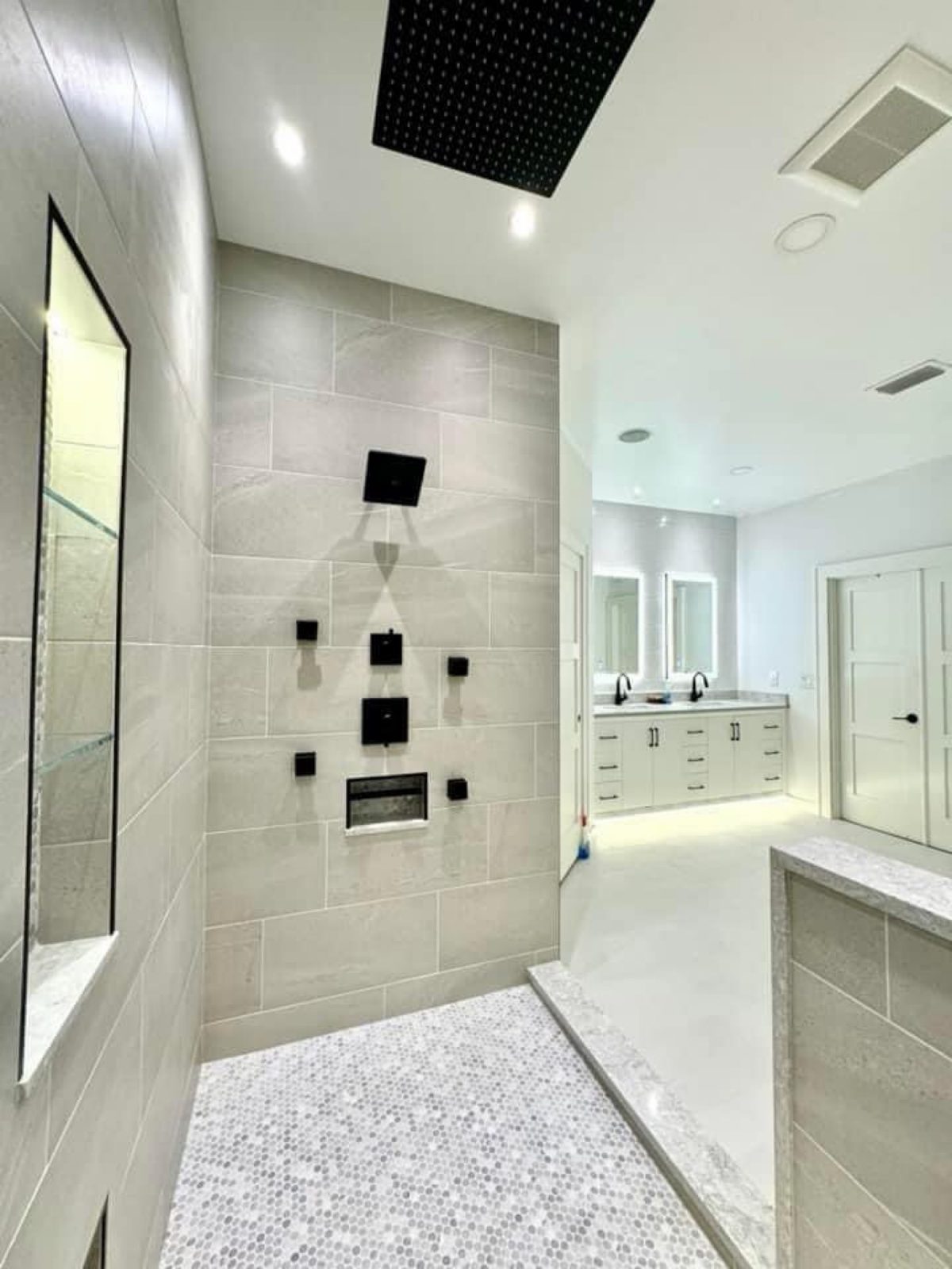 Custom tile shower with body jets and penny-tile floor