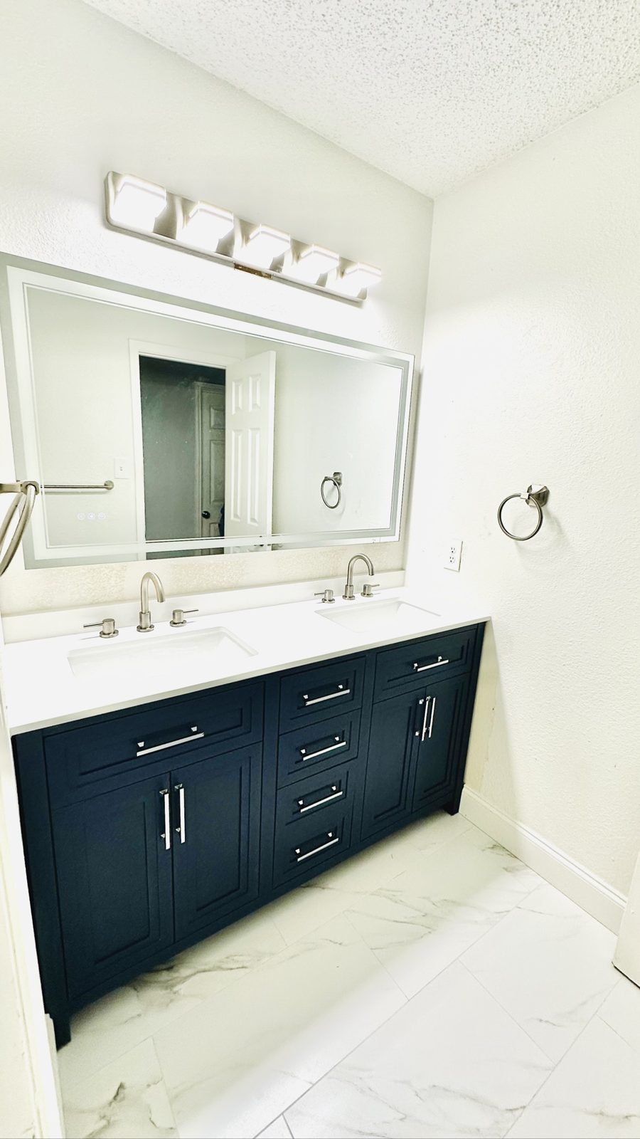 New double vanity with lighted mirror and brushed nickel faucets